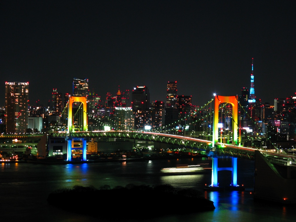 Photo:  Rainbow_colored_Rainbow_Bridge_at_night